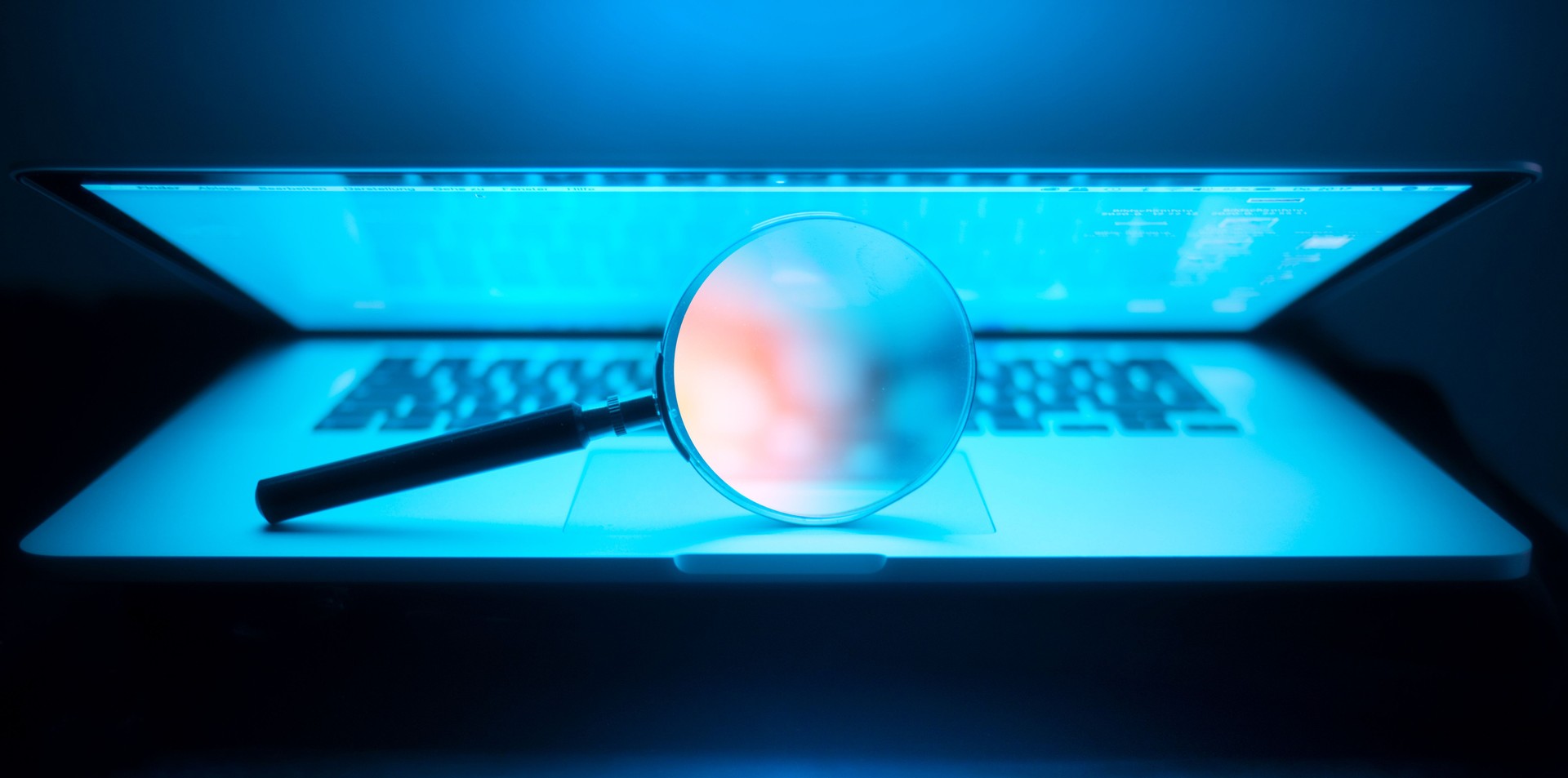 Magnifying glass in the laptop in the dark